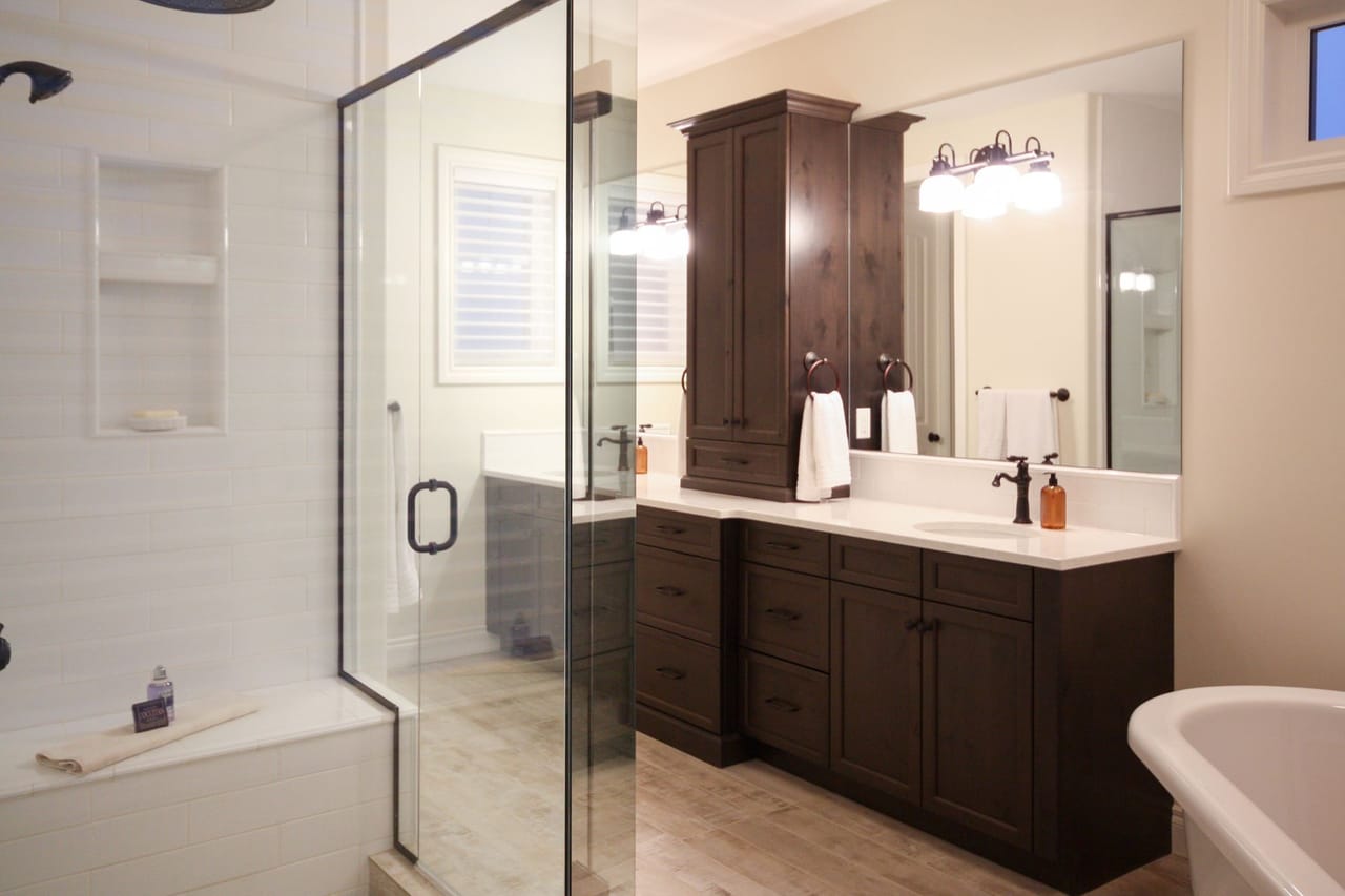 A modern ensuite bathroom with custom tile and vanity