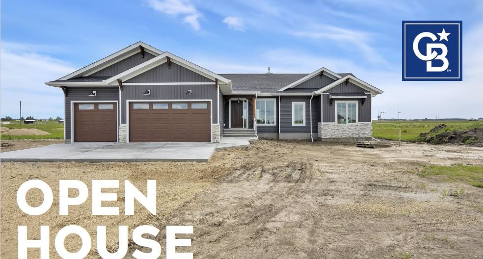 A custom home exterior with a triple garage photographed at dusk